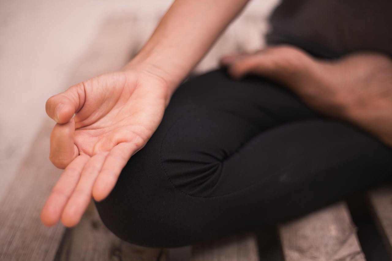 Close-up of a hand in a meditation pose, focusing on mindfulness and calmness.