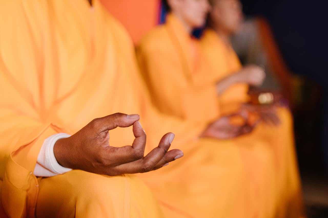 Monks in robes practicing meditation, focusing on inner peace and mindfulness.